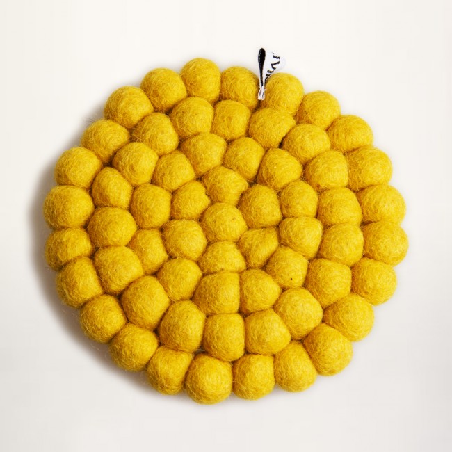 yellow coaster of felt balls