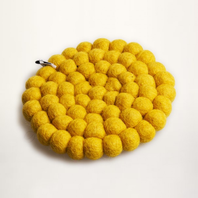 yellow coaster of felt balls