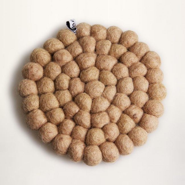 Sand colored coaster of felt balls