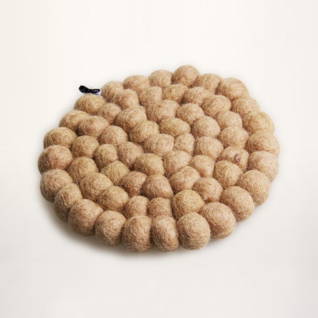Sand colored coaster of felt balls